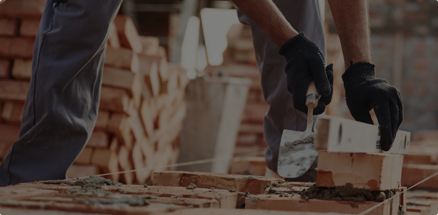 Construction worker laying bricks on a job site